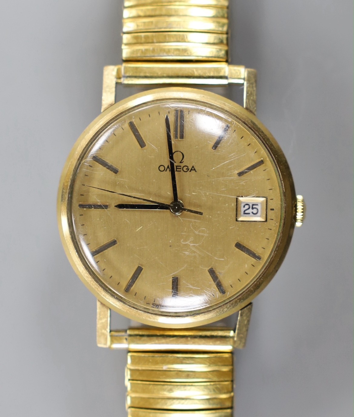 A gentleman's 1960' yellow metal Omega manual wind wrist watch, with date aperture, on associated flexible bracelet, no box or papers.